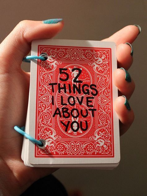 Hand holding handmade 52 Things I Love About You card deck, perfect for personal and romantic gifts.