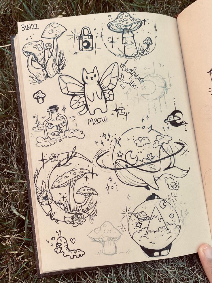 e230f2d1-8f8b-4023-927b-e326ddddaa3b Whimsical sketchbook page with mushroom, cat fairy, and planet doodles on grass background. | Sky Rye Design Whimsical sketchbook page with mushroom, cat fairy, and planet doodles on grass background.