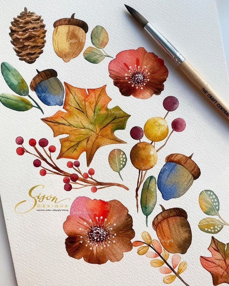 Watercolor painting of autumn leaves, acorns, and berries with a paintbrush on paper.