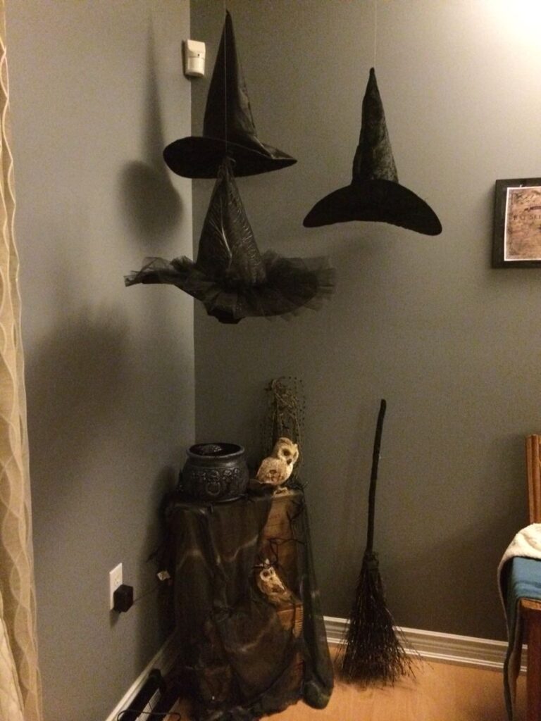 f21c024afbcc5516aa1604e38bab566d Floating witch hats, broomstick, and cauldron in a cozy room corner create a spooky Halloween atmosphere. | Sky Rye Design Floating witch hats, broomstick, and cauldron in a cozy room corner create a spooky Halloween atmosphere.