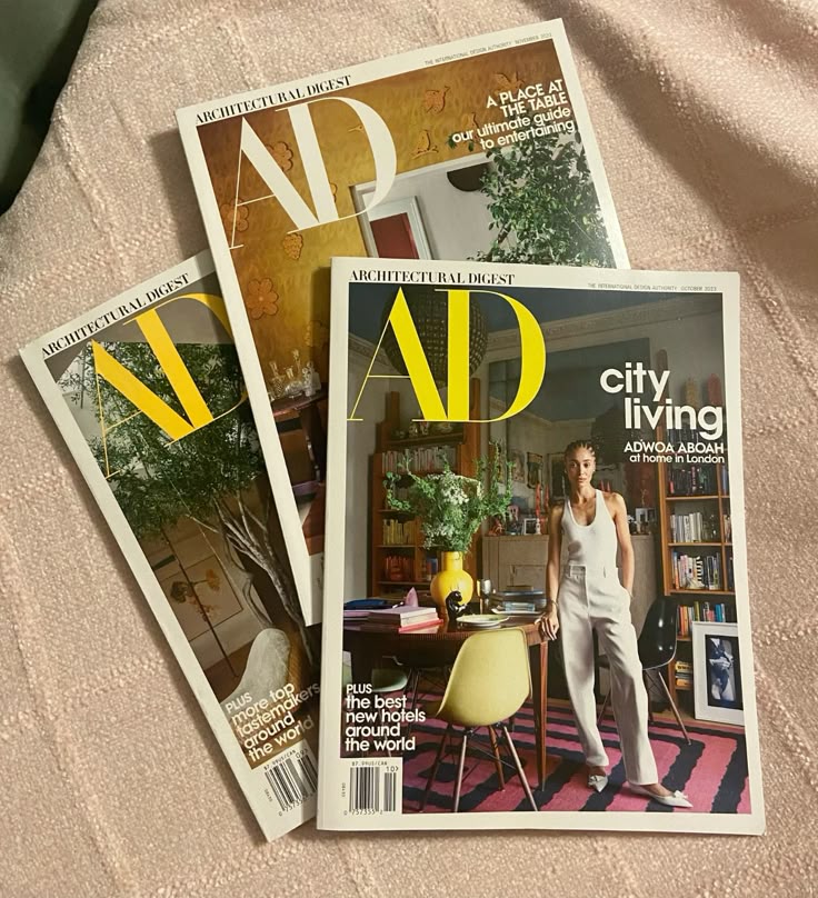 Architectural Digest magazine issues on a soft surface, featuring stylish interior designs and decor ideas.