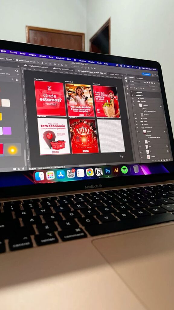 A laptop screen displaying graphic design work in Adobe Photoshop, showing creative marketing materials.