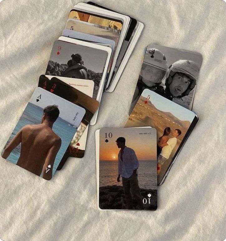 Deck of personalized photo playing cards with memories on a soft white background, featuring scenic and personal images.