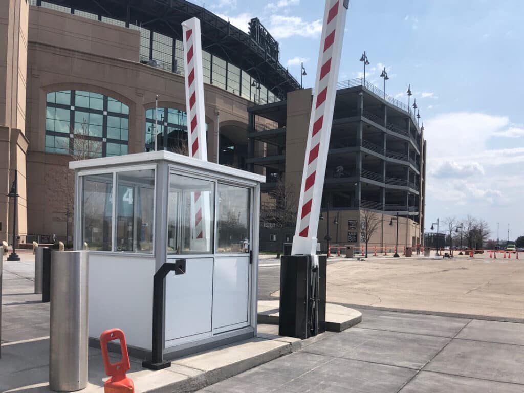 g-4000-fixed-drop-arm-barrier-M50 Security booth and barrier gate at stadium parking entrance on a sunny day. | Sky Rye Design Security booth and barrier gate at stadium parking entrance on a sunny day.