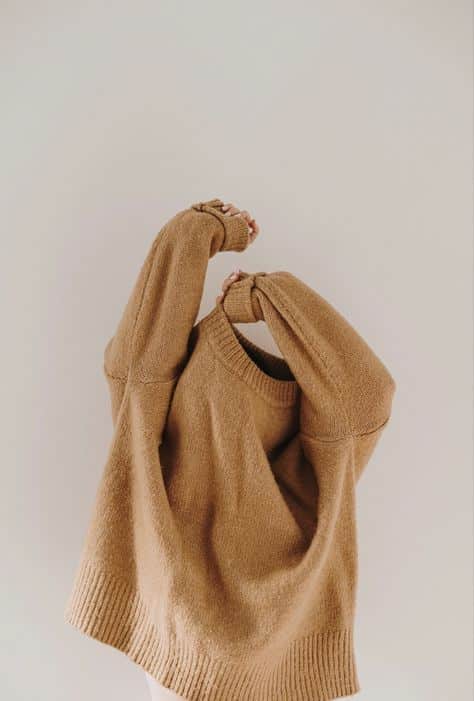 Cozy oversized brown sweater with long sleeves against a plain backdrop.