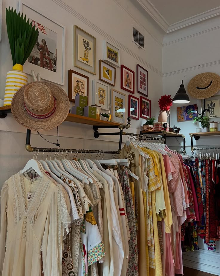 Vintage clothing store with colorful dresses and eclectic wall art.