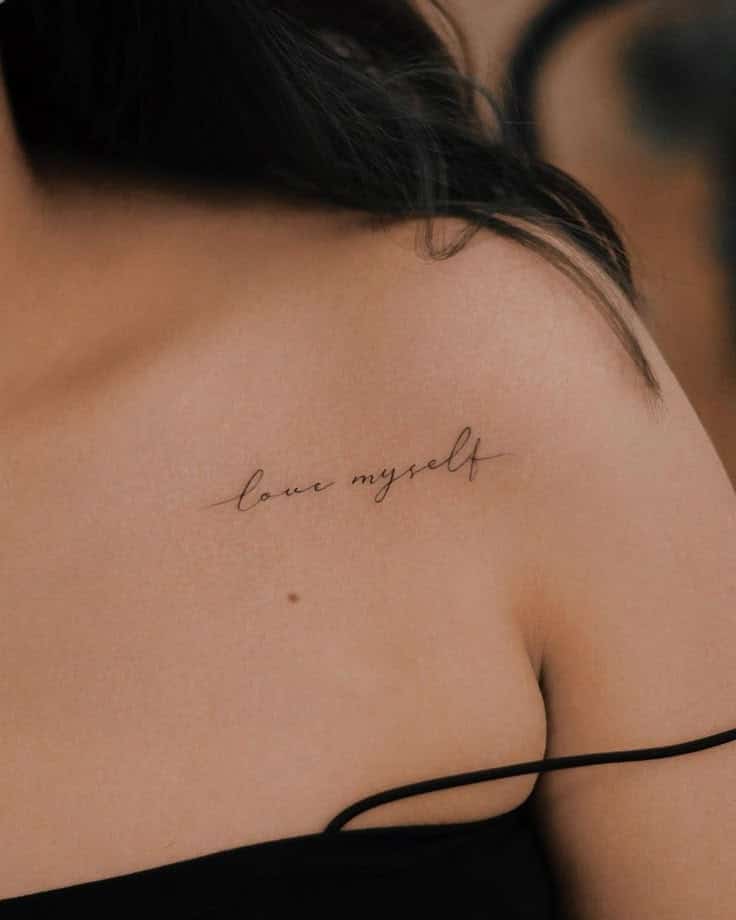 Close-up of a love myself tattoo on a person's shoulder, symbolizing self-love and positivity.