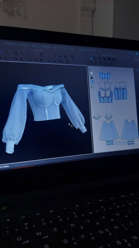 m8hdie clo3d 3D clothing design on a computer screen, featuring an off-shoulder top with puffed sleeves and pattern drafts. | Sky Rye Design 3D clothing design on a computer screen, featuring an off-shoulder top with puffed sleeves and pattern drafts.