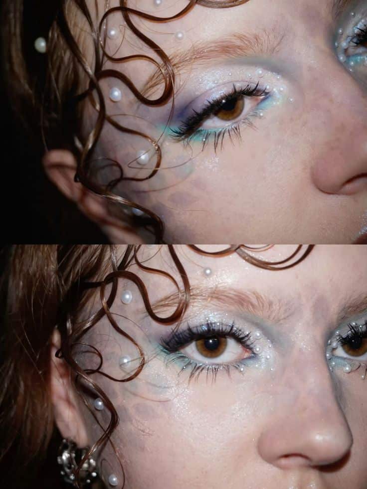 Close-up of a creative eye makeup with pearls and blue tones, featuring curly hair strands. Fashion and beauty concept.