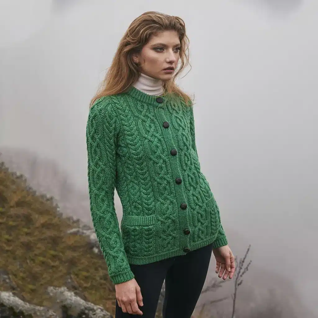 ml115-105-ladies-button-cardigan-lifestyle-1-saol_1024x10242x Woman in green cable knit sweater standing in misty outdoor setting. | Sky Rye Design Woman in green cable knit sweater standing in misty outdoor setting.