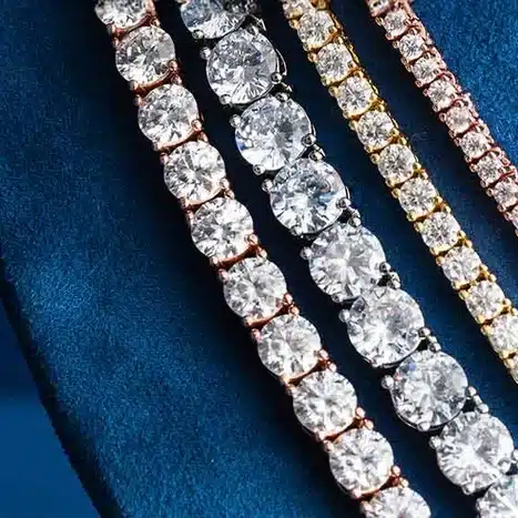 Elegant diamond bracelets on a blue velvet surface, showcasing sparkling gemstones and luxurious design.