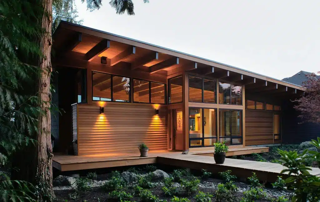 nw-modern-featured Modern wooden house exterior with large windows and garden path at dusk. | Sky Rye Design Modern wooden house exterior with large windows and garden path at dusk.