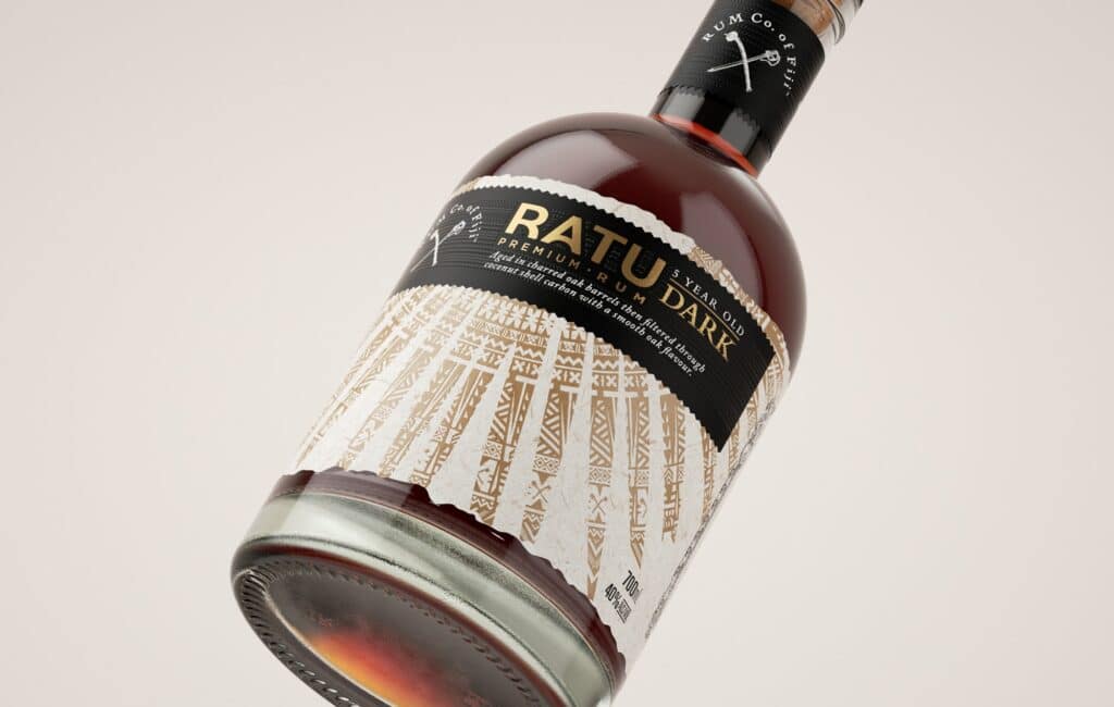 rcof-packaging-alcohol-08 Bottle of Ratu Dark Rum, 5-year-old premium spirit with elegant label design, tilted on a light background. | Sky Rye Design Bottle of Ratu Dark Rum, 5-year-old premium spirit with elegant label design, tilted on a light background.