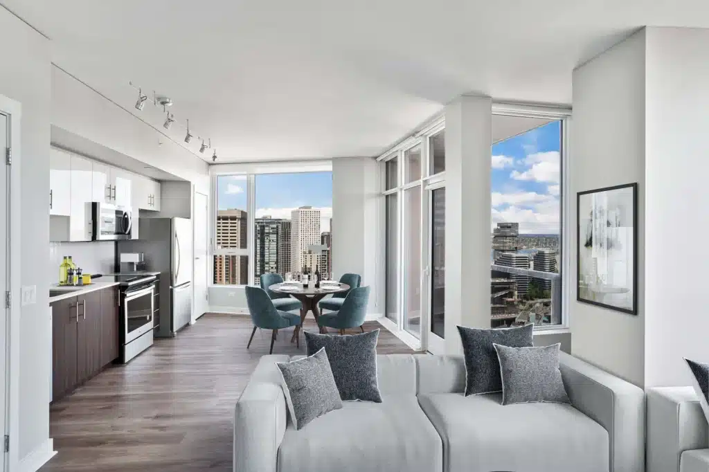 shoootin-photo-14_Web-2 Modern open-concept apartment with city view, featuring sleek kitchen, dining area, and cozy living space. | Sky Rye Design Modern open-concept apartment with city view, featuring sleek kitchen, dining area, and cozy living space.