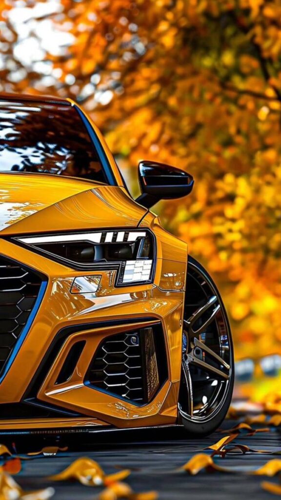 Sporty yellow car in autumn setting with striking front design and sleek headlights.