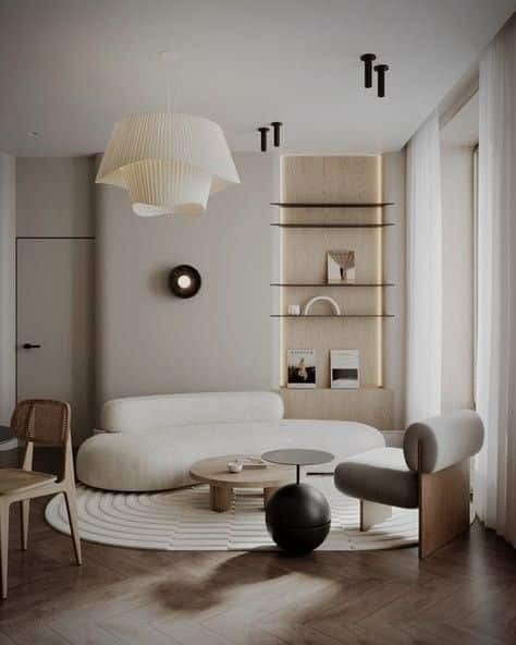 _ Modern living room with neutral tones, curved sofa, round coffee table, and stylish lighting. Minimalist decor. | Sky Rye Design Modern living room with neutral tones, curved sofa, round coffee table, and stylish lighting. Minimalist decor.
