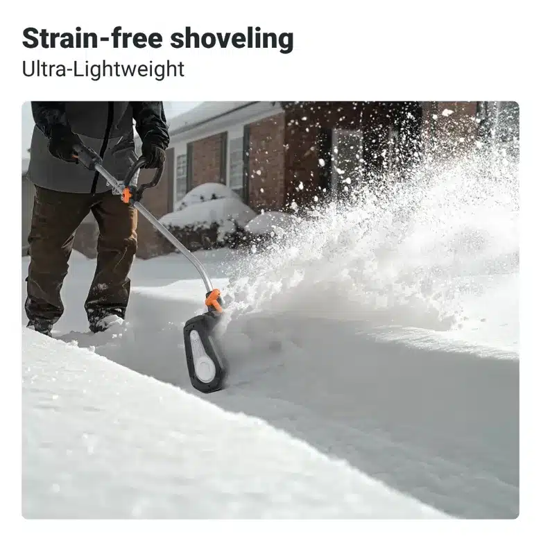 Person using lightweight snow shovel for easy, strain-free shoveling in snowy driveway, next to brick house.