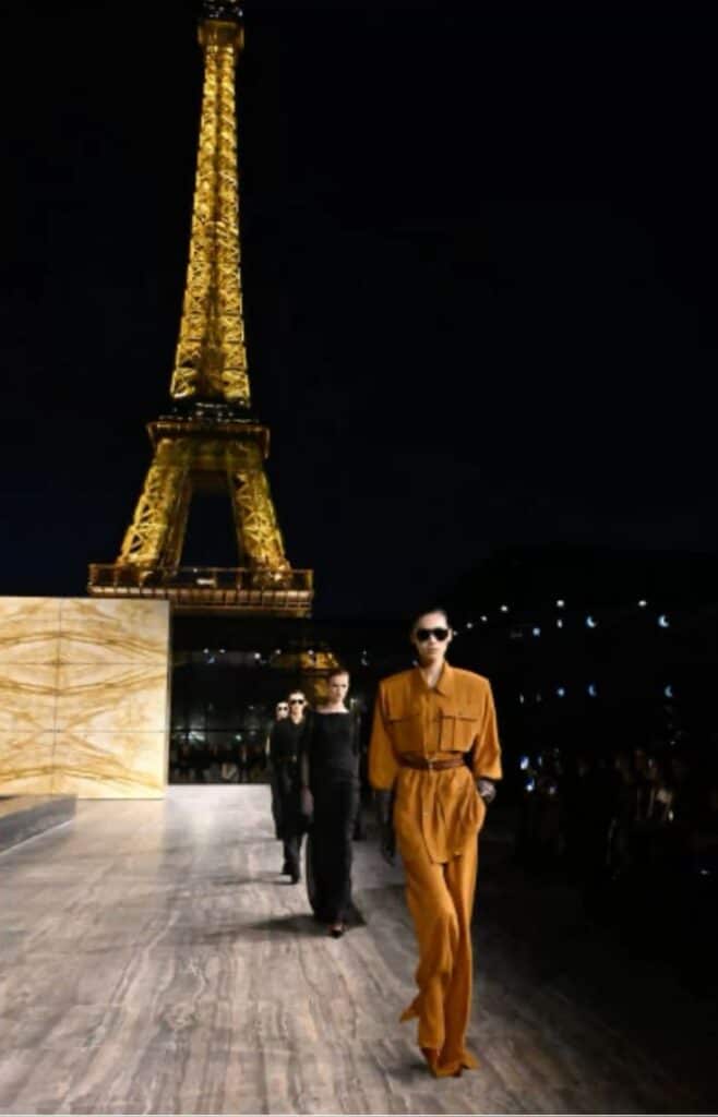 ysl fashion show paris france Fashion show in Paris: models in stylish outfits walking past the illuminated Eiffel Tower at night. | Sky Rye Design Fashion show in Paris: models in stylish outfits walking past the illuminated Eiffel Tower at night.