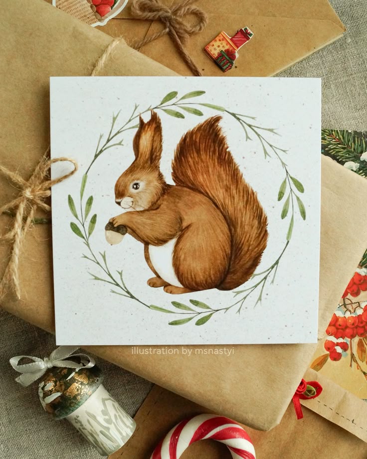 Illustration of a squirrel with a nut on a festive card surrounded by gift wrapping and Christmas decorations.