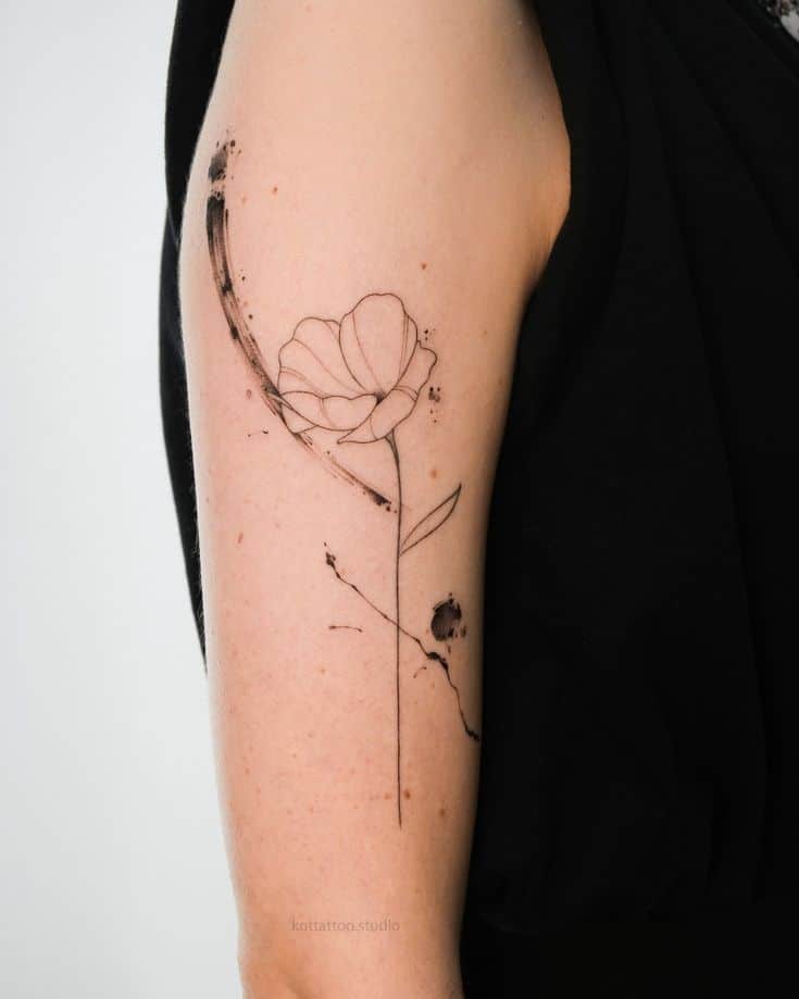 Minimalist flower tattoo on upper arm with geometric lines and black ink accents.