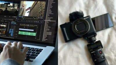 Person editing video on laptop next to a camera with flip screen and controls on a bed.
