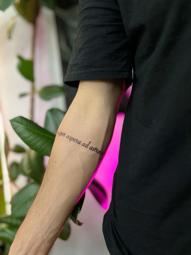 Надпись тату Arm with Latin tattoo Per aspera ad astra surrounded by green plants and soft pink lighting. | Sky Rye Design Arm with Latin tattoo Per aspera ad astra surrounded by green plants and soft pink lighting.