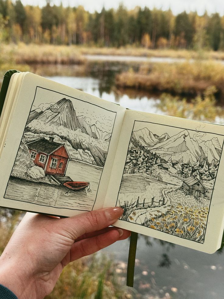 Рисунок гор скетч Sketchbook with hand-drawn landscapes of mountains and cabins, held outdoors by a serene lake with trees in the background. | Sky Rye Design Sketchbook with hand-drawn landscapes of mountains and cabins, held outdoors by a serene lake with trees in the background.