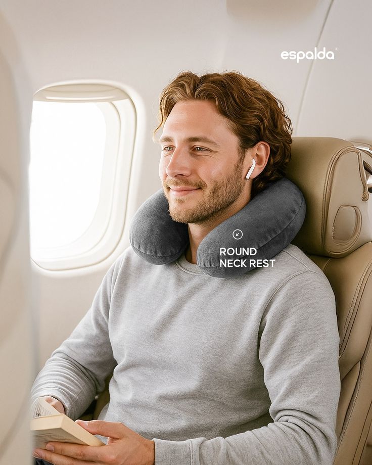 ✈️ Flying shouldnt be tiring_ Say goodbye to Man relaxing on airplane with gray neck pillow, wearing earbuds, and holding a book. Cozy travel essentials for comfort. | Sky Rye Design Man relaxing on airplane with gray neck pillow, wearing earbuds, and holding a book. Cozy travel essentials for comfort.