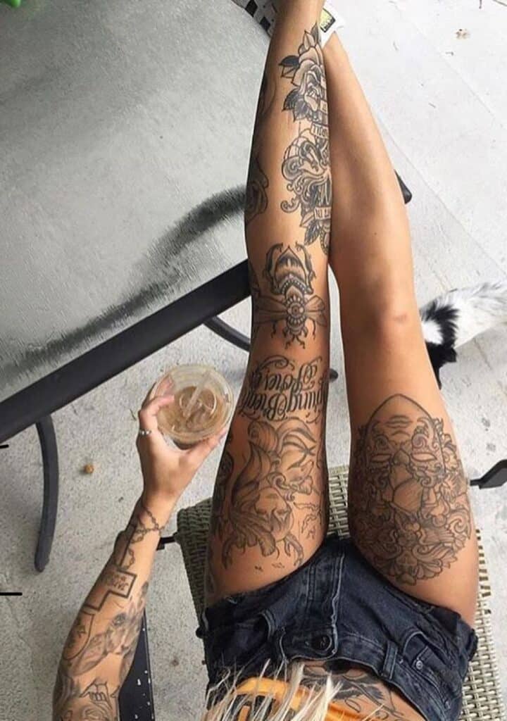 ❤️ Person with detailed leg tattoos resting with iced drink outdoors, showcasing unique body art style. | Sky Rye Design Person with detailed leg tattoos resting with iced drink outdoors, showcasing unique body art style.