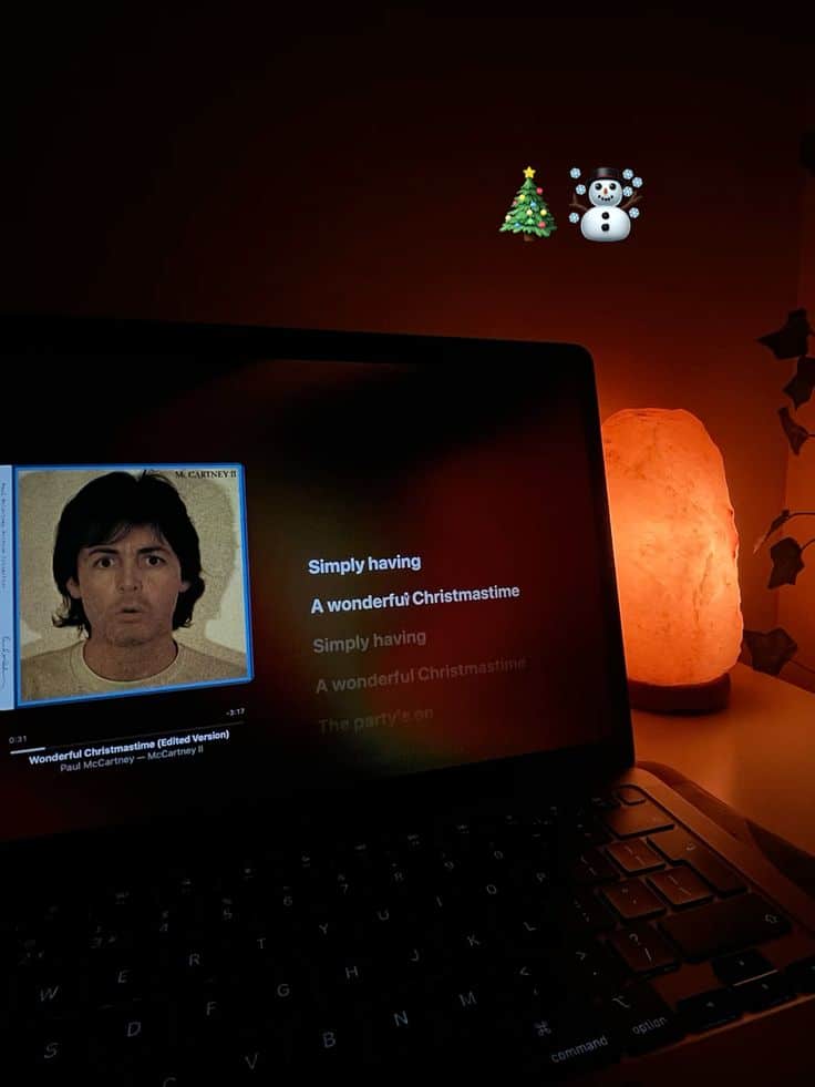 🎄☃️ Cozy Christmas scene with laptop playing festive music, decorated with a Christmas tree and snowman emoji. | Sky Rye Design Cozy Christmas scene with laptop playing festive music, decorated with a Christmas tree and snowman emoji.