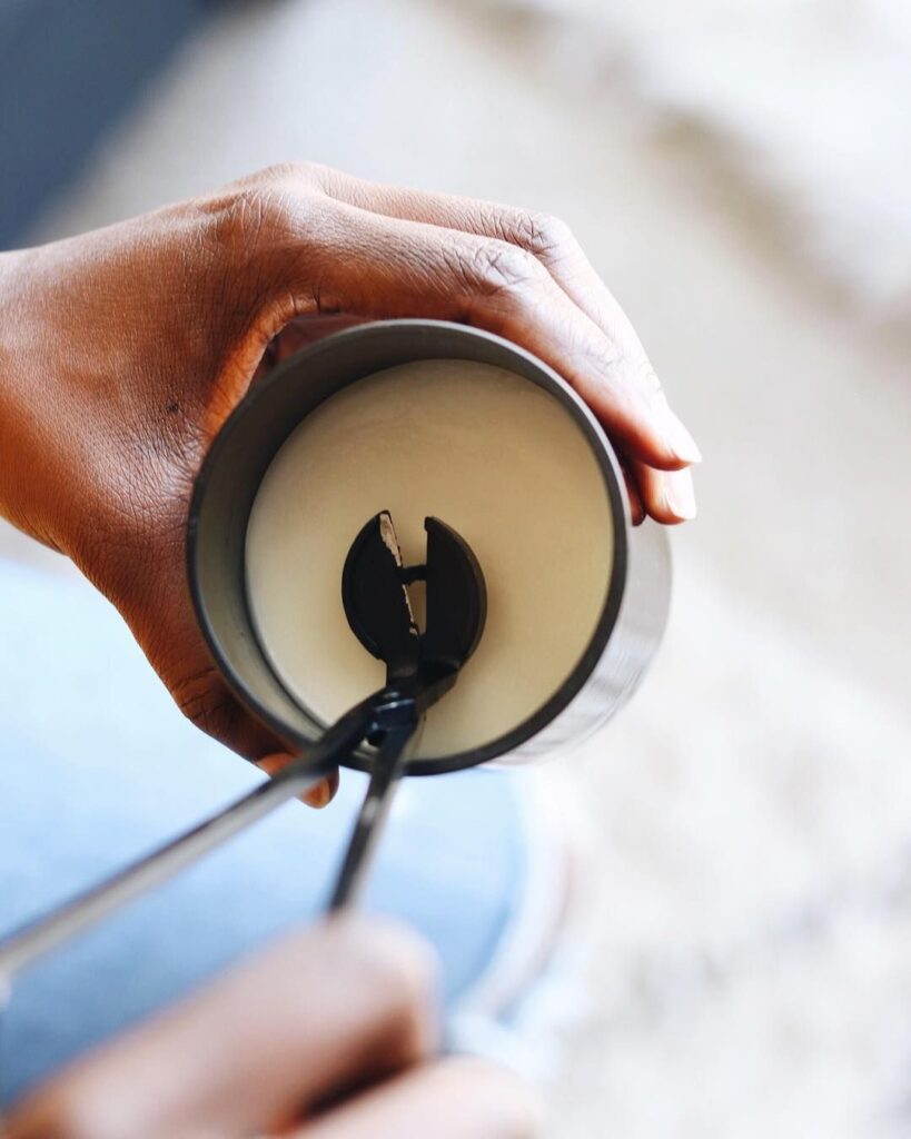 02f64b312da5287646d0aa6fe221664a Hand trimming a candle wick with scissors for optimal burn and longer-lasting flame. | Sky Rye Design Hand trimming a candle wick with scissors for optimal burn and longer-lasting flame.