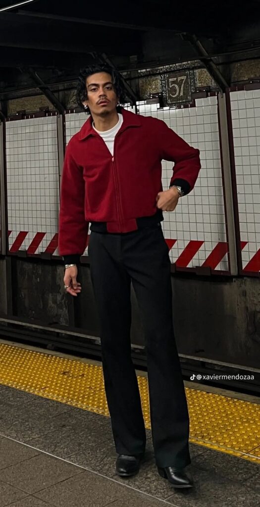 04468255-40e1-4c5d-8335-951dac62bc46 Man in a red jacket and black pants standing in a subway station. | Sky Rye Design Man in a red jacket and black pants standing in a subway station.
