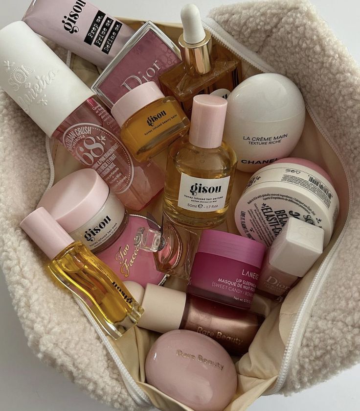 086eb977-ccec-41d5-9e6c-0d46a5bd1ce9 Assorted beauty products in a cozy bag, featuring skincare, fragrances, and cosmetics from various popular brands. | Sky Rye Design Assorted beauty products in a cozy bag, featuring skincare, fragrances, and cosmetics from various popular brands.