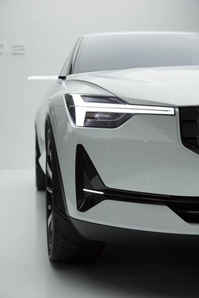 0b72e9b56e578dd5c1bfefb3fa4c3108 Sleek modern white electric car front view with LED headlights in a minimalist setting. | Sky Rye Design Sleek modern white electric car front view with LED headlights in a minimalist setting.