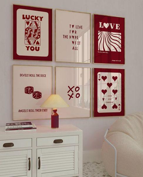 0ebcd61a-d76e-4101-8092-404507ce926f Gallery wall with red and cream motivational posters above a white cabinet and lamp. | Sky Rye Design Gallery wall with red and cream motivational posters above a white cabinet and lamp.