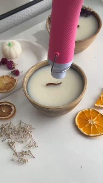 _ 1 Heating a wooden wick in a candle with dried oranges and flowers for decorative crafts. | Sky Rye Design Heating a wooden wick in a candle with dried oranges and flowers for decorative crafts.