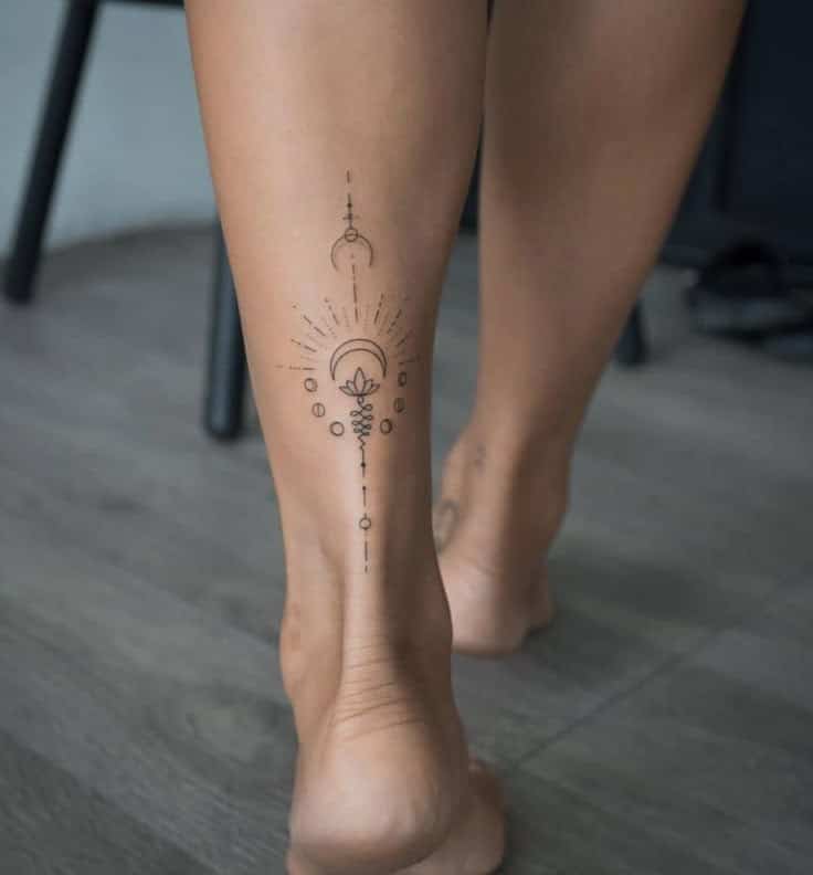 _ 1 Geometric tattoo on calf with celestial design, crescent moon, and lotus. Minimalist black ink on smooth skin. | Sky Rye Design Geometric tattoo on calf with celestial design, crescent moon, and lotus. Minimalist black ink on smooth skin.