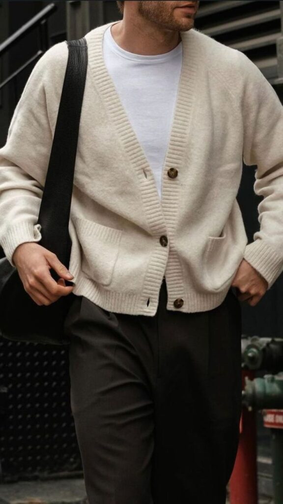 100+ Office Old Money Looks You Need To Try Right Now 3 Man in beige cardigan and white shirt, holding a bag, walking on the street. Casual men's fashion. | Sky Rye Design Man in beige cardigan and white shirt, holding a bag, walking on the street. Casual men's fashion.