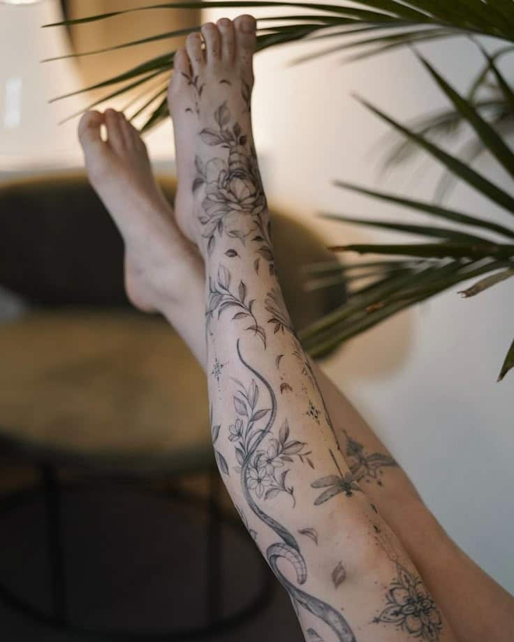 100 Trippy Tattoos For The Lovers of Psychedelic Art Tattooed legs with floral designs and greenery in background for artistic inspiration and body art ideas. | Sky Rye Design Tattooed legs with floral designs and greenery in background for artistic inspiration and body art ideas.