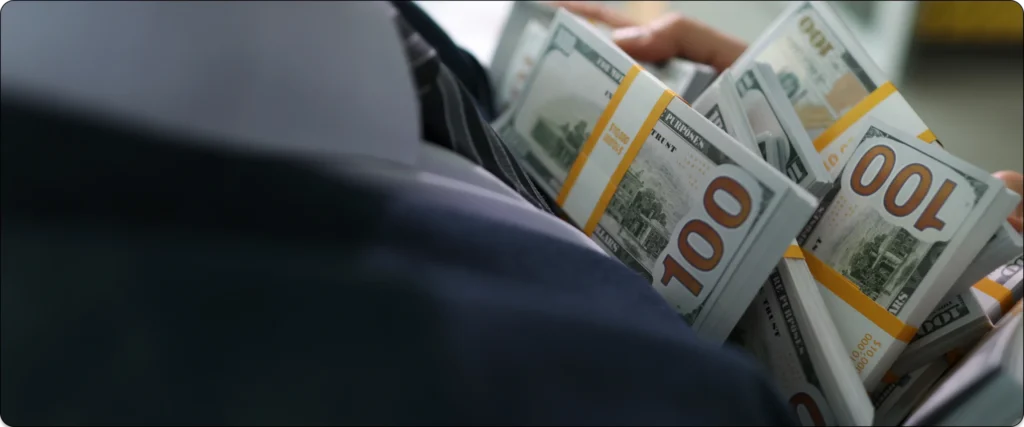 Stacks of hundred-dollar bills wrapped in bands, symbolizing wealth and financial success.