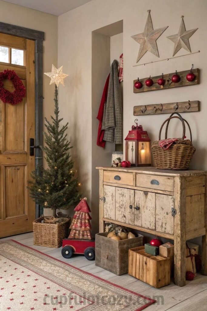 Rustic Christmas entryway with tree, wreath, vintage decor, and lantern in cozy farmhouse style.