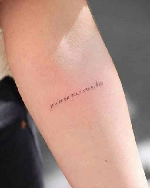 _ 13 Arm tattoo with the text you're on your own, kid in small, delicate font. | Sky Rye Design Arm tattoo with the text you're on your own, kid in small, delicate font.