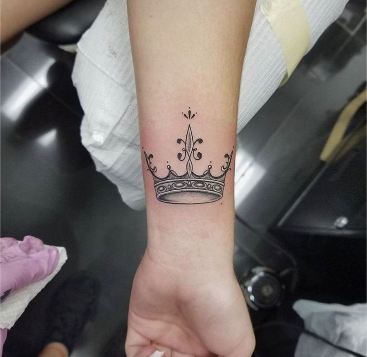 _ 13 Simple black crown tattoo on a forearm, showcasing elegance and royal symbolism. | Sky Rye Design Simple black crown tattoo on a forearm, showcasing elegance and royal symbolism.