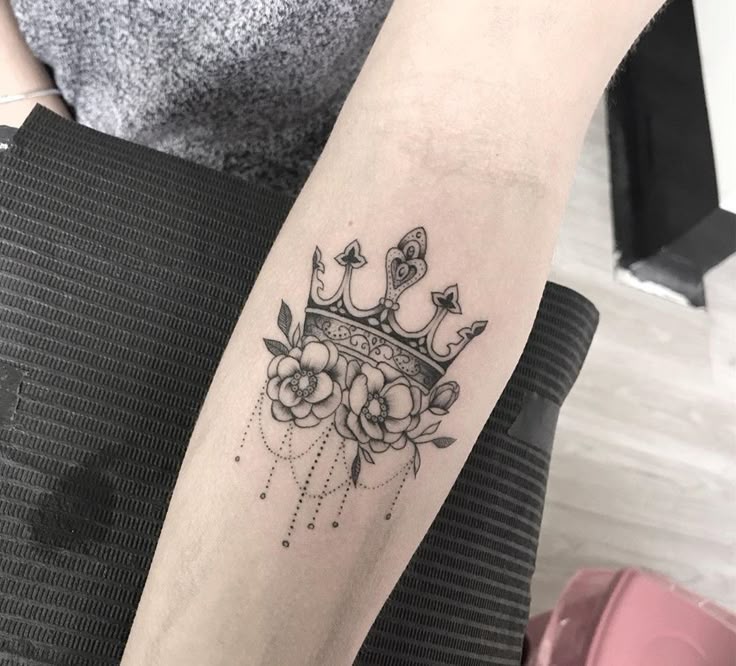 _ 14 Tattoo of a crown with floral designs and ornamental details on forearm. | Sky Rye Design Tattoo of a crown with floral designs and ornamental details on forearm.