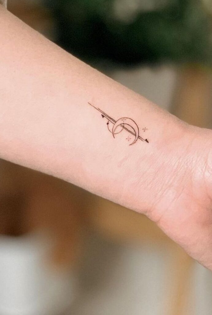 _ 14 Minimalist arrow and crescent moon tattoo on forearm, featuring delicate line art style. | Sky Rye Design Minimalist arrow and crescent moon tattoo on forearm, featuring delicate line art style.
