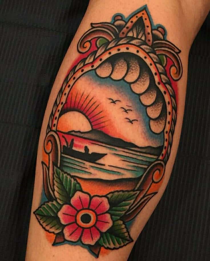 Colorful tattoo of a sunset, fishing boat, and flower in a traditional style on an arm.