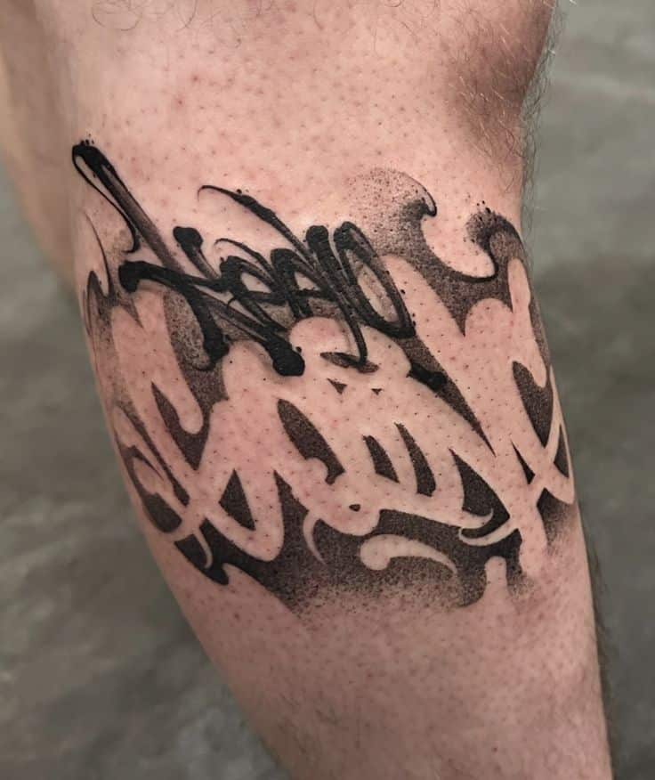 Abstract black ink tattoo design on forearm with intricate patterns and shading.