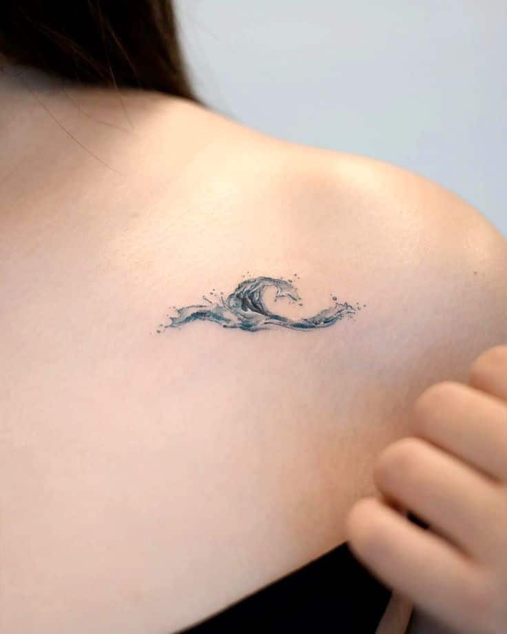 17 Unique Ocean Tattoo Ideas_ Bold Designs to Inspire You Minimalist wave tattoo on a woman's shoulder, symbolizing the ocean's power and beauty. | Sky Rye Design Minimalist wave tattoo on a woman's shoulder, symbolizing the ocean's power and beauty.