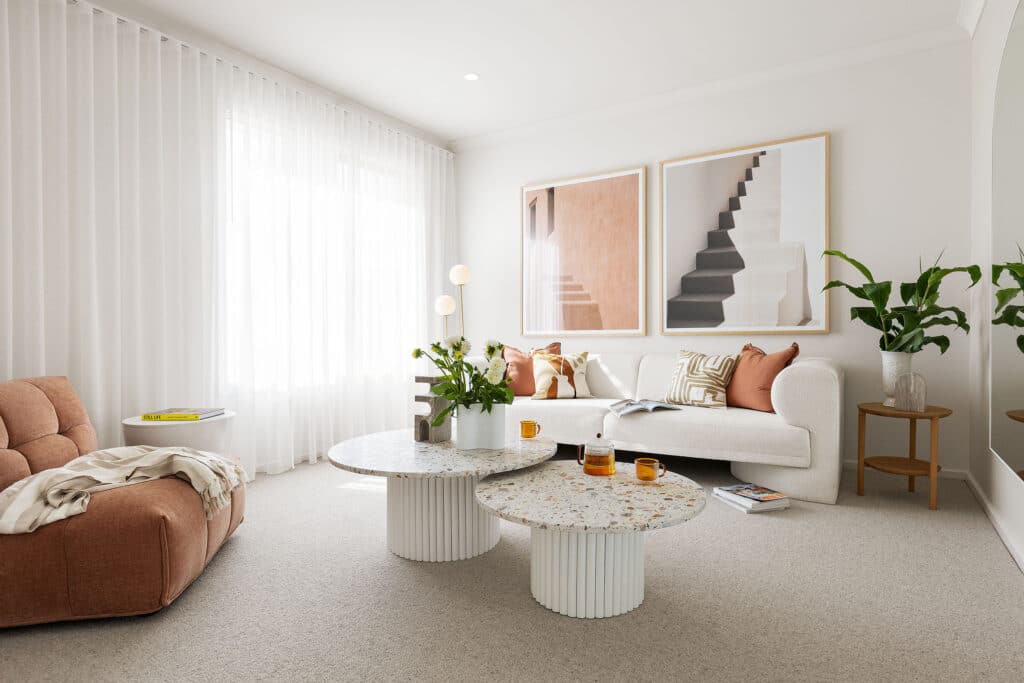 1732782782_original Modern living room with white sofa, terrazzo tables, and large wall art; natural light and plants enhance the cozy space. | Sky Rye Design Modern living room with white sofa, terrazzo tables, and large wall art; natural light and plants enhance the cozy space.