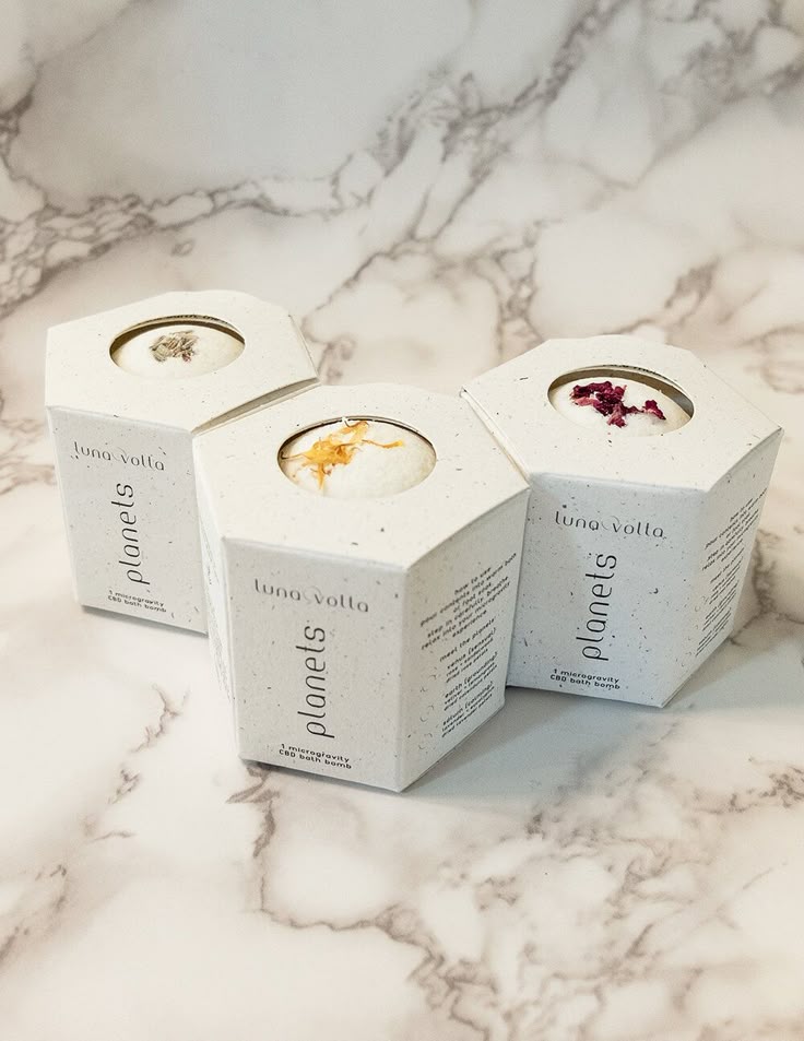 17a41634375267dfab5bb8f98d0440ad Three hexagonal boxes of Luna Volta Planets CBD bath bombs on a marble surface. | Sky Rye Design Three hexagonal boxes of Luna Volta Planets CBD bath bombs on a marble surface.